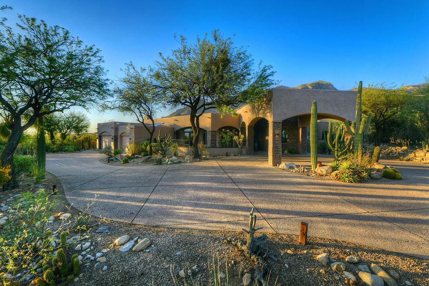 Beautiful mountain and city views surround this gorgeous Pima Canyon home. 4 bedrooms, 4 bathrooms in well designed split bedroom floor plan. A flex space that could be used as an activity/playroom/homework room leads to two generously sized en suite guest bedrooms. Large master suite with attached office or workout room and spa-like master bathroom. High end finishes throughout including travertine floors, granite countertops, and 8 ft alder doors. Three fireplaces, gourmet chef's kitchen with large walk-in pantry, expansive laundry room w/ butler's pantry an entertainers family room and backyard. A resort style pool and spa with panoramic views, large covered patio and rooftop deck with hot tub create the ultimate resort lifestyle in the center of the Catalina Foothills. The list of upgrades and features is extensive w/ owned solar, large 3 car garage, porte cochere entry, expansive covered patios in both front and backyards, remarkable finishes and a well thought out floor plan.