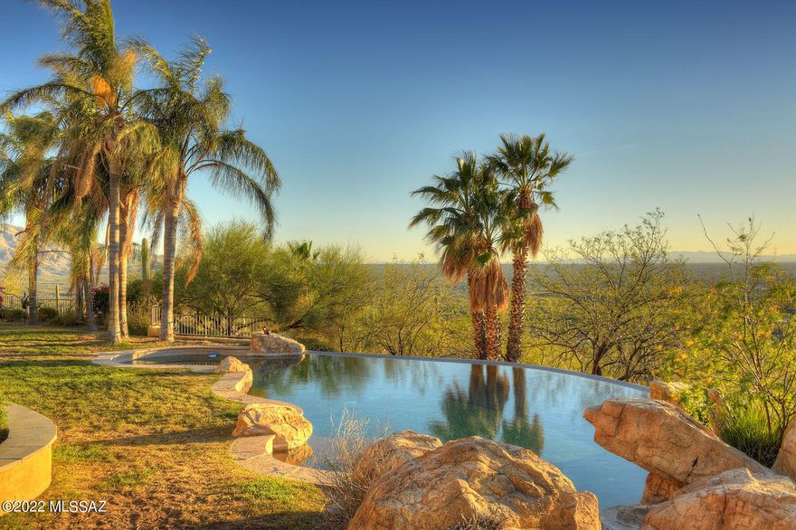 Rare opportunity to own a hilltop residence with 360 degree views on 3.7 acres.  This palatial estate has it all:  over 4500 sq. ft. of elegance: Handcrafted wood, wrought iron, copper and natural stone floors of the highest quality throughout home.  Spectacular 4 sided fireplace with hammered copper hood sets the tone. Elegant formal dining room to wrap around patios for dining options.  Kitchen is a chef's delight with commercial size Viking stove, hand crafted cabinetry with burled wood inserts, prep island, 2 dishwashers & full butler's pantry with wine fridge and storage.  Two owners' suites with sitting rooms are grandly proportioned with fireplaces, jetted tubs, spacious showers and well-thought out closets. Pool and spa will compete with the views for attention.  3 ½ car garage has room for 5 cars complements of 2 car lift bays.  Don't miss the full size bocce ball court, fire pit with banco seating as you explore the grounds. The gated community of Redington Ranch has a lake, stables, horse trailer storage, pool, tennis & club house.