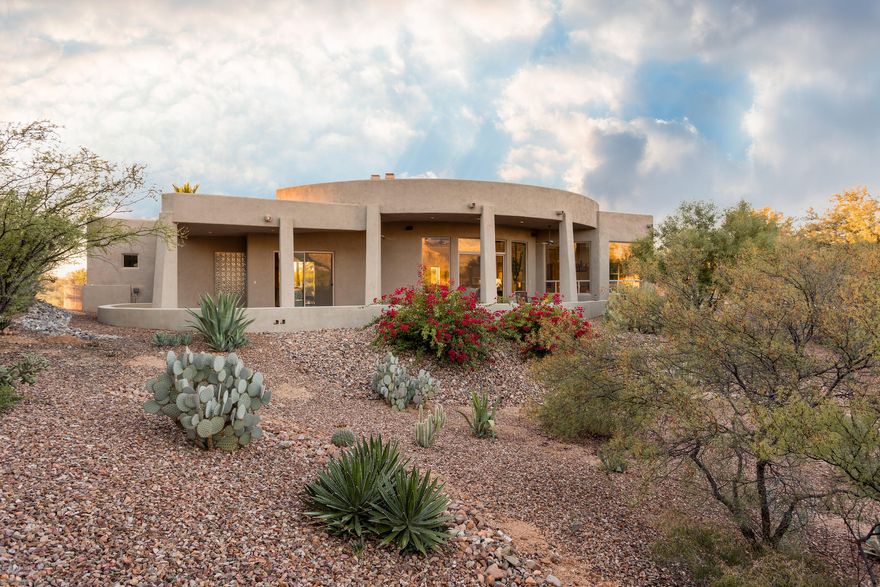 Stunning contemporary on premier lot in gated Palisades Point Estates.  Spacious and open with amazing 360 degree views. Over 1400 sq ft of covered outdoor living space includes the rear patio with pebble tec pool, outdoor kitchen and fireplace as well as the expansive front patio offering some of the best mountain views in Oro Valley. The split bedroom plan is ideal for guests and offers a bonus room ideal for den or additional office.  Amenities include 18'' Travertine tile and slate flooring, alder wood cabinets, extensive recessed lighting, commercial grade misting system on rear patio, 3 fireplaces, a built-in office in fourth bedroom, niches throughout  as well as a wall of built-ins in the 3 car garage.