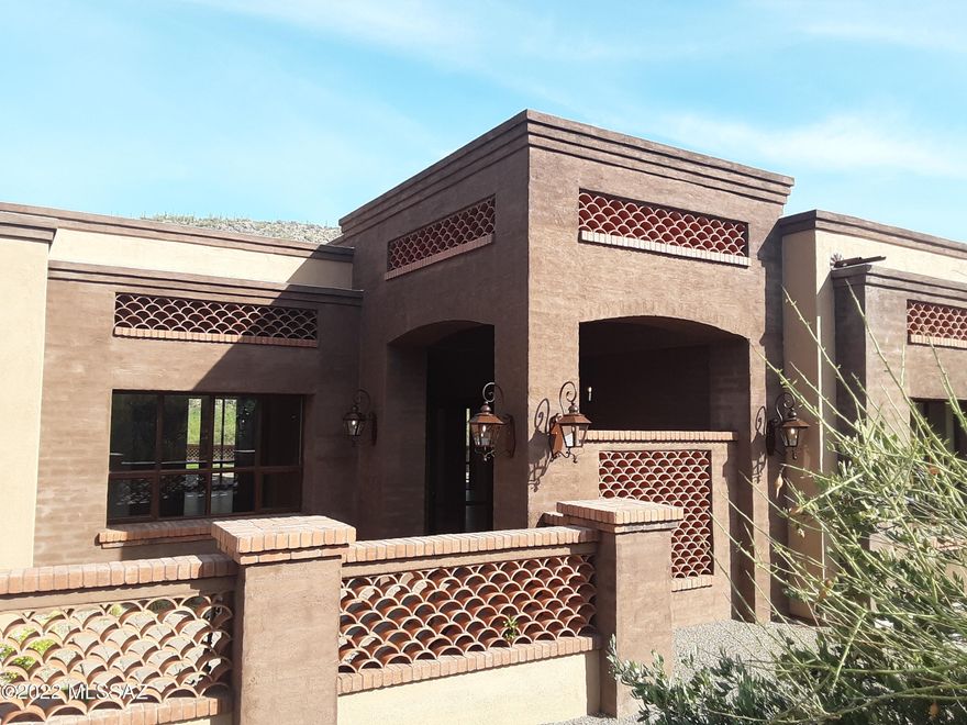 Spectacular views from this new Quintana Partners LLC construction nestled on the Gallery golf course between the 3rd hole & 4th tee box. This contemporary southwest design features a Great Room w/ 14' ceilings, Integral color plaster Foyer, Solid 8' Alder doors. Custom Alder cabinetry, Thermador Appliances, 10' kitchen island w/ waterfall edges and a Wine closet. Prewired for speakers in Great room, Master Suite and Patios, 3 Bedrooms and Office /Den, 3 and 1/2 baths. Low maintenance landscaping on a drip system.
Artificial turf and desert landscaping. Available for additional cost, there is a backyard plan from Pools by Design.