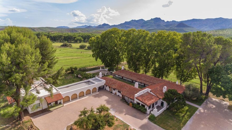 This stunning 1930s style ranch is situated along the banks of the Santa Cruz river Riparian area in Santa Cruz County & easily accessible via I-19.  Only 45 minutes south of Tucson yet a world apart, this beautiful property has been meticulously remodeled.  With a 4317 square foot  4 bedroom 3.5 bath main house and an adjoining 750 square foot one bedroom and one bath fully equipped guest casita as well as over 2800 square feet of covered porches; this property is truly remarkable. With a tile roof, 5 zone AC, a workshop, 80 acres of irrigated pasture, refinished floors, copper gutters, an orchard with 15 fruit trees, a water harvesting system and upgrades throughout the home and casita this property strikes the perfect balance between functional and yet exquisite. *SEE ADDITIONAL* The irrigated pastures, round pen, pipe corrals as well as the towering shaded trees provide an excellent opportunity for a manageable horse operation or a sustainable farm. 

Located just south of the thriving artisan and historic community of Tubac, this property is nestled along the Santa Cruz river, home to the largest natural cottonwood/willow forest in the United States.These types of properties are indeed rare in Arizona. This ranch affords old world charm with contemporary upgrades which fit perfectly with todays discerning buyer