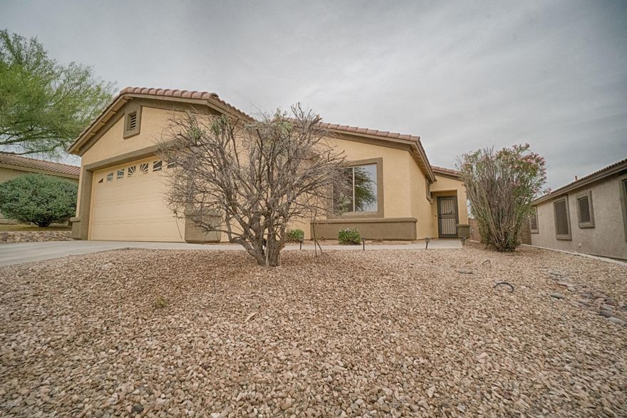 Move-in ready home in the Villages at Dove Mountain. Open floor concept with split bedroom plan.  Great room with fan and fireplace. Generous size eat-in kitchen with lots of cabinets and pantry. Slider off of kitchen to covered patio and large backyard. You will love the size of the laundry room and the extended garage.  The home has recently been painted outside as well as several interior rooms.  All the Dove mountain amenities including parks, walking paths, tennis and volley ball courts are nearby.