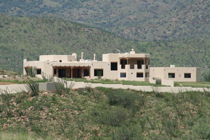 Sensational large custom home on 77 acres built on a hill with 3 BR and 4 BA with office/library and family room/den. Incredible 360 degree views and 1/4 miles of frontage on Bond Canyon Creek Riparian area below the home. Awesome views from every window! 4,800 sq ft in the home and 2,900 sq ft in a heated & cooled 6 car garage. 7,700 total square feet plus very large porches with an outdoor fireplace. That is one of 5 fireplaces. Property is located at the prestigious 20,000 acre Salero Ranch between Tubac and Patagonia at an ideal 4,200 elevation. Sparkling pool, spa, BBQ, helipad, seasonal creek, private well house and 2 electric gates all on 77 acres. Excellent seller carryback financing available for qualified buyers. Must see. This is an incredible value!