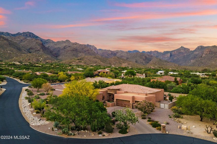 Discover your dream home in the exclusive gated community of Ventana Reserve! This desirable Catalina Foothills gem boasts breathtaking mountain views from the east-facing backyard. The spectacularly designed home with 3814 sqft of living space, five bedrooms, and 4.5 bathrooms has everything you need with a stunning gourmet kitchen complimented by custom granite slab countertops, two-tone kitchen cabinetry, SS appliances, a gas cooktop, and exquisite designer finishes carefully chosen throughout the home, from the convenient butler's pantry to the beautiful polished travertine floors. Enter into the open living room featuring a floor-to-ceiling stone fireplace, soaring ceilings, and an expansive wall of windows entrenching the room with natural lighting. The primary suite offers two walk -in closets, a snail shower, a soaking tub, and dual, separate vanities. Two secondary bedrooms feature en suite baths. The casita provides the perfect space for guests or a home office with a separate entrance. You'll be the envy of all your friends with the entertainer's dream backyard, a true retreat featuring a stone fireplace gathering area, a spool with a soothing yet eye-pleasing water feature to cool off on those warmer summer days, and a turf area for a pop of color. The premium lot location on nearly an acre and professionally desertscaped front and rear yards make the home all the more appealing. The new top-of-the-line HVAC system installed last year ensures your comfort all year round. Don't miss this opportunity to live in this meticulously maintained home in one of the most sought-after communities in Tucson.