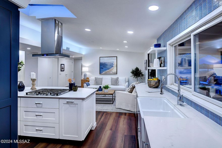 Its rare to find a home in Historic Indian Ridge. Remodeled with every attention to detail.Shades of blue, navy and white cabinetry, whisper white walls, and a plethora of windows invite the outdoors in. Open kitchen anchors the home with a large island and seating for all. A separate den and even a workroom!  This home went over budget but it is fabulous.  Even kitchen cabinets are custom. Living is so gracious, so serene, and so livable! Large covered patio, beautiful brick accents, and turf that is big enough for all sorts of things! Solar is owned, roof under warranty, it is one of my favorites.  Neighborhood?  Ask me...  I live in there! Indian Ridge, a historic neighborhood that is a Tucson treasure. The kind of neighborhood that has a 4th of July parade complete with decorated cars and trucks, kids on bicycles, and even a fire engine to start things off. Magical luminaries line the streets on Christmas. There is even a traditional "Retro on the Ridge" party with a new theme every year. A place where it folks walk, people wave, someone will let you know if your dog is out , but still a feeling of privacy.