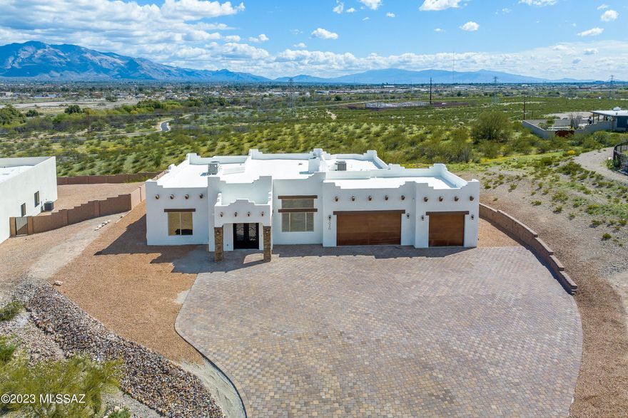 $15,000 SELLER CREDIT for window coverings, landscaping, etc.  Panoramic mountain & city light vistas from this acre view lot. Adjacent to the bike path. Spacious, open, split floor plan w/four bedrooms plus a media room/office. Features include a whirlpool bath; soft-close cabinets; stainless Frigidaire Gallery appliances and hood including a 27.8 cf. fridge; gas & electric ovens plus microwave; pot filler; 10 ft bedroom and 12 ft main room ceilings; eight-foot entry & interior doors; gas/wood fireplace; dual Rheem HVAC systems; living room, media room and master BR wired for surround sound; 11 ceiling fans; 12 fluorescent fixtures on five zones in the garage;  lots of room to entertain, inside and on the large covered patio which has a connection for a natural gas grill