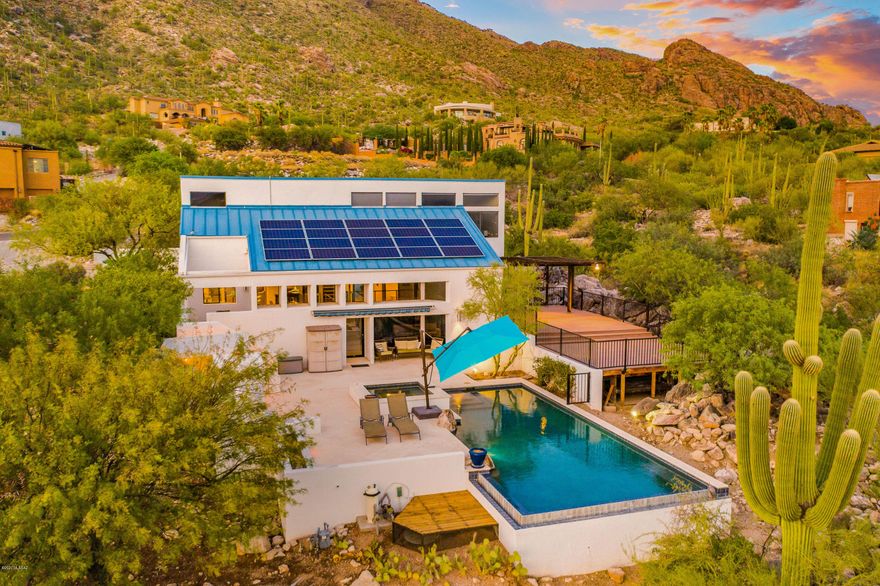 Majestic ridge-top home sitting on 1.08  acre lot, Located in the upscale Catalina Foothills. Unobstructed panoramic  360 degree mountain and city views! Enter through the charming front courtyard and walk in to see straight through to the city. This home has .3BR/2.5BA totaling 2524 SF, Custom home w/ tri-level open great room floor plan. Spacious kitchen w/maple cabinetry,beautiful granite countertops, gourmet stainless steel kitchen appliances.,Formal dining, Split floor plan offers, large master suite w/walk-in closet, & separate shower. travertine  floors.Resort style back yard hosts; negative edge pool, spa,,fire place ,outdoor bar & expansive back patio deck. FULLY OWNED SOLAR!