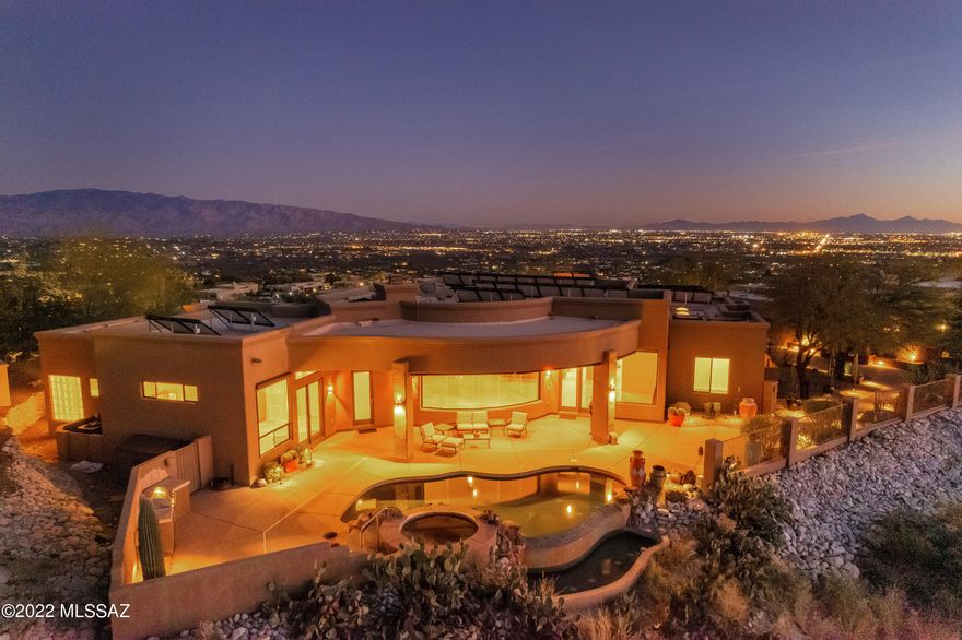 This beautiful property perched high atop a ridge inside Sabino Mountain gated community boasts breathtaking panoramic 360 degree  views of the Catalina, Rincon , Santa Rita, Tucson Mountains and Spectacular city views.
Relax or entertain your guests on two separate built-in barbecue areas while enjoying the views and dipping in the pool and spa.

Spacious great room flows smoothly  through the fully equipped  kitchen and the dining area. Walk-in pantry , granite tops, gas and electric ovens makes it chef's delight.  Wide and high windows around the house peacefully invite in the views. Let the fully-owned solar system harness the advantages of the Arizona sun. 
Spacious rooms with private bathrooms, plenty of storage areas inside the house and the three-car garage. High ceilings, indoor and outdoor fireplace make this gem warm and inviting.