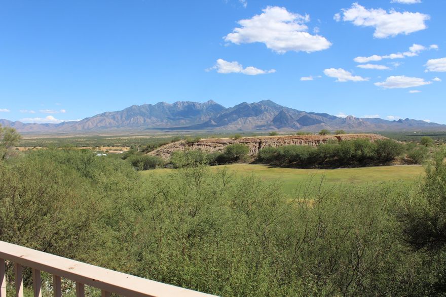 If magnificent views of the mountains and golf course are high on your list...this home is a MUST see. From the moment you step into the courtyard entrance and hear the sound of water coming from the fountain (conveys) you'll be smitten. You enter the home into a circular foyer with a soaring ceiling and arches that lead to the living room and another arch to the kitchen. There is a gas FP with a fan that will keep you toasty warm on a cold winter's night. The beautiful kitchen has granite counters, a wine refrigerator that conveys as well as plenty of counter & cabinet space. In back are WOW views of the golf course and mountains. This special home has a screened in AZ room that adds living space nearly year-round. A perfect spot for watching southwest sunrises & sunsets.