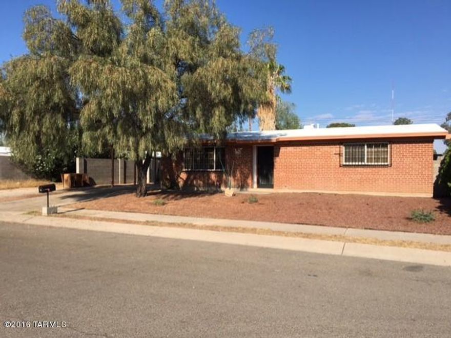 Beautiful 3br 2ba brick home.Gorgeous, updated kitchen that has custom Alder cabinets, granite counters, portable island, recessed lighting and black appliances. 3 year old porcelain tile throughout. Newer Dual pane windows. The 16 seer Air conditioner was installed in 2010. Nice size master bedroom with walk-in closet and a second smaller closet, updated hall bath,numerous ceiling fans, cozy Family room has very nice wood trim and a wood tongue and groove ceiling. Block wall surrounds the big rear yard. Covered, shady patio,storage shed and more storage above the carport.Must see.