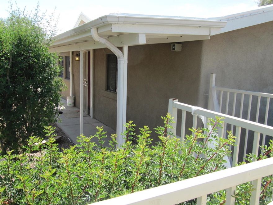 UofA prop located on CatTran w/i 200'of home & 2 miles biking to campus! Stuccoed permanently attached MH in the perfect location! FEATS: NEW roof w/white coating w/polyester membrane over vinyl; NEW carpet; Freshly painted inside; Updated kitch & baths w/stainless appl, hickory cabinets & slate counters! NEW masonry wall just installed to enclose big yard! Home has gutters & downspouts, covered patio/walkway & a concrete sidewalk that goes completely around the house. Wired for alarm system, has motion detector spotlights in the front of home & a wrought iron security fence. Taxes are very low on this property. Newer 12 Seer A/C. National Home Warranty & 5 year termite contract in place for new owner! Plenty of parking, ideal for those attending UofA. Flood insurance required with loans.