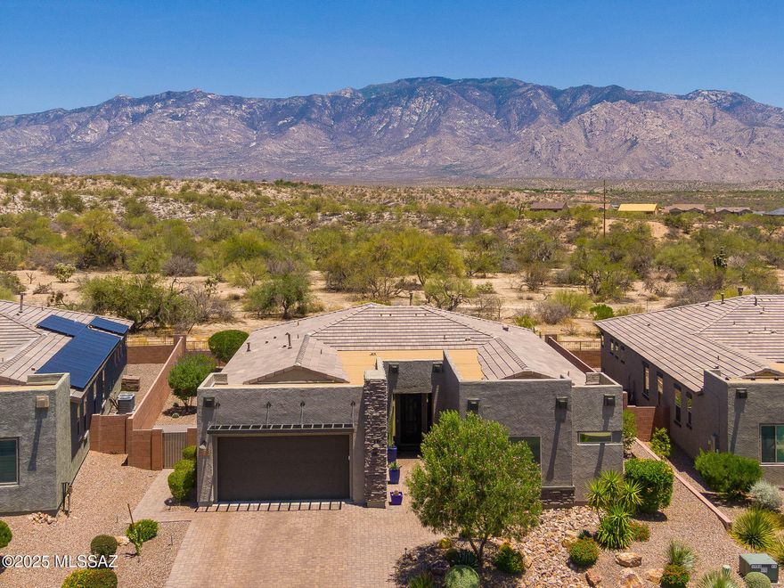 Spectacular Mountain Views from a premium lot! This upgraded Mattamy Patina plan is located in the gated community of Alterra Vistoso Trails in Oro Valley. Offering 2,336 sqft, this 3 bedroom+den features a split-bedroom plan, expansive great room w/12' center sliding glass door & electric shade for effortless comfort & light control. All tile thru-out. Chef's kitchen includes granite countertops, under-cabinet lighting, roll-out shelves, & soft close cabinets. 36'' gas cooktop, built in oven/microwave w/custom walk-in pantry. Extended cabinetry & granite countertops in the dining area for ideal living & entertaining. Two guest rooms share a convenient Jack&Jill bathroom. Retreat to a luxurious primary suite w/double sinks, walk in shower & soaking tub. Custom walk-in closet & private access to the patio. Step outside to your private oasis. A professionally landscaped backyard with artificial turf, built-in BBQ, gas firepit and electric Sunsetter awning. Other upgrades include a custom wrought iron front door, epoxied garage floor with custom shelving, whole-house water softener, and under-sink RO system. Gorgeous views, luxury finishes and unmatched privacy.