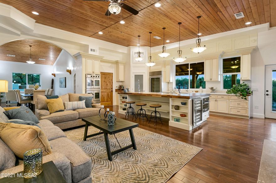 Utilities and Pool maintenance included. 
 Spectacular Spanish Colonial custom built home thoughtfully designed to accommodate multiple generations.  In the heart of Catalina Foothills School District.
The floor plan provides private living for all generations with the ability to enjoy time together and the many amenities including hiking and biking trails near the property.
On the main level, is a spectacular kitchen with massive island.  Subzero fridge, quartz and granite countertops, dual dishwashers, ovens and sinks allow multiple chefs to work comfortably.  A walk-in pantry and plenty of cabinet space will keep the clutter out of sight.  The kitchen opens to a large great room with stunning electric fireplace and a spacious patio from which to enjoy the city.  Owner/agent The master bedroom features a spectacular view of the mountains, with dual walk-in closets off the spacious bathroom.  The adjoining office is also accessible from the entry hallway.  A guest suite with lovely Mountain View's will be a haven for visitors.  
The main floor has high ceilings, solid walnut and chestnut wood flooring, lots of natural light and spacious rooms with city or mountain view's.
The formal dining room is perfect for entertaining.  It can accommodate seating for 20 for those large family meals.  
One of the custom curved staircases winds up to the roof deck with 360 views to continue the party on top of the world.
The other curved staircase leads down to the 1st level and the more relaxed spaces.    3 bedrooms and 2 bathrooms and a 2nd kitchen open to the lower great room which flows smoothly into the north yard and the picturesque views to be enjoyed from there.  The kids can escape to the media room and enjoy a private home theater.  
The entrance to the home is thru an arched gateway.  The custom glass and iron front door is complimented by an authentic iron bell that can be operated to announce visitors.
Spanning the entire side of the home is the north yard.  A fully walled in rose garden provides a peaceful escape on the north east corner.  An Endless Pool SwimSpa with calming fountain caps the opposite end of the yard. In the middle is the outdoor dining room and kitchen.  All in view of the Catalina mountains.  
The west side of the home contains a large open yard area with views of the adjoining wash and charming cactus garden. The property connects to a hiking trail thru the neighborhood wash.  
The south side opens to the terraced gardens and the 2nd garage.
The home is constructed with 12" thick masonry walls and super-insulation to keep the home quiet and comfortable.  
Individual air conditioners for each major room allow you to personalize your temperature and ensure that all inhabitants are able to isolate safely from the others.  
Solar power, gray water reclamation and water harvesting are built in to this luxurious and efficient home.