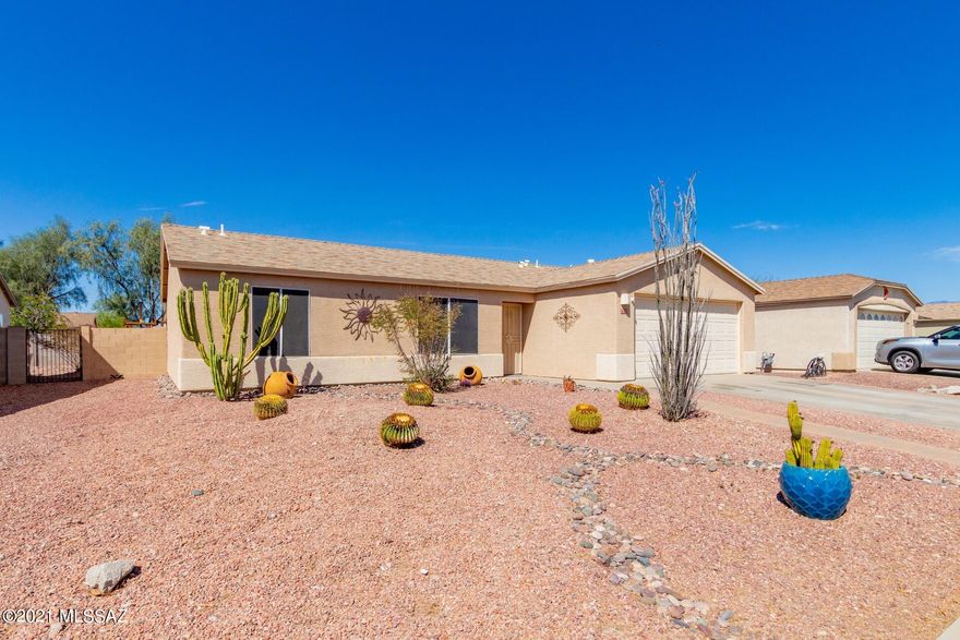 Gorgeous single level home w/great curb appeal.  Sensational backyard setting w/a sparkling fenced pool, covered patio, artificial turf, & colorful plants.  Perfect outdoor entertaining space. Soaring ceilings, custom palette, upgraded ceilings, beautiful tile floors, window blinds, & patio access from the dining area. Plenty of wood kitchen cabinets, SS appliances, pantry, double sink, pet door, & lots of counter space. Generous size bedrooms, ample closets, wonderful laminate wood floors,  Do not miss out on this desert gem.