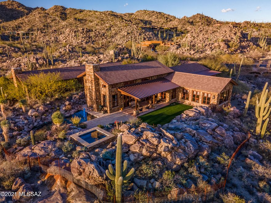 Rock Solid - Featured in Luxe Magazine - McHallam Construction and Ron Robinette came together and built a one of a kind Fortress. Masonry constructed with 2x4 fur out along with real stone veneer made for massive thick walls. Intergral colored 3 coat cementatious stucco, pitched roof with concrete tile and standing seam metal roofing leaving no flat roof to be found. Double layered sound proof between bedrooms, laundry and study, wire brushed cedar french casement windows, 3 true masonry chimney wood burning fireplaces, exposed re-sawn fir beams and tongue and groove ceilings, walnut wood  & antique  french limestone flooring, custom hand painted (Farrow and Ball) cabinetry. Wide open spaces in your dream kitchen looking out into great room and dinning.  Marble, Limestone and soapstone countertop surfaces, Hans Grohe plumbing fixtures, Urban Electric lighting fixtures and Jean De Merry to name a few of the high end quality finishes that went into this beautiful home.  Lutron Lighting controls, low voltage recessed lighting throughout with built-in surround sound.  Master Bedroom and Bathroom beautifully done with separate vanities -  TV Mirror at vanity - Separate tub and steam shower - fireplace beautifully faced with antique french limestone. Backyard features salt water pool, water feature and raised spa nicely tucked into the rock outcroppings for maximum views and privacy.  Membership required to the Stone Canyon Club. Tour of this home and development amenities can be scheduled 7 days a week. Stone Canyon continuously ranks among the top Golf Clubs in the country.