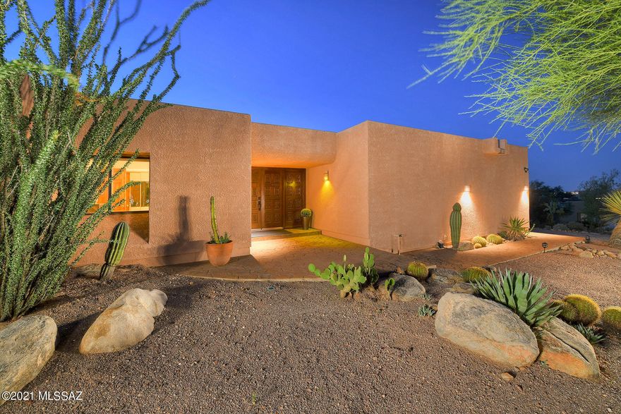 This single story, modern ranch home sits on just short of an acre, in the exclusive Sin Vacas neighborhood! This entertainer's dream home features 2,450 square feet of living space with 3 bedrooms, 2 bathrooms, and an office. Enjoy tons of natural light throughout the amazing floor plan with raised ceilings, multiple skylights, and walls of windows and French doors. Parking is spacious with an oversized 2 car garage and a separate RV garage. The kitchen features an electric range with hood,stainless steel refrigerator, and dishwasher.  The kitchen opens to one of the most beautiful views of the Catalinas Tucson can offer. This home also offers a living room and dining area with a wet bar that is perfect for intimate family gatherings or large celebrations. The large primary bedroom has a walk-in closet and can accommodate a cozy sitting area with direct access to the beautiful backyard and outdoor shower. The large, super-private backyard is a true oasis and features a covered patio, and pool with a breathtaking view of the Catalinas. If you enjoy the sunrise, the sunset or both, this home has the spot for you.  As a plus, you would be the 2nd owner of the meticulously cared for home. Simply move in and create new memories! You're only minutes away from entertainment, restaurants and shopping at Tucson's very own La Encantada shopping center. Hurry this home will not last!