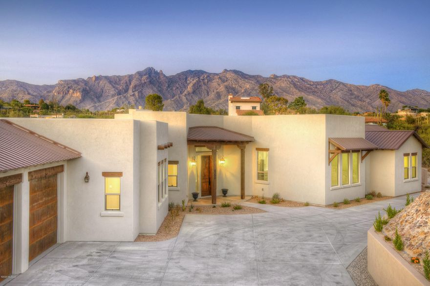 Gorgeous Brand New Luxury Home in the heart of the foothills with incredible mountain views, walls of windows to soak them in and stunning top of the line finishes thruout.  Features include sky high ceilings, split floorplan, enormous greatroom with a gas fireplace, beautiful island kitchen with quartz countertops and stainless steel THOR appliances that will surely delight the ultimate chef in your household.   Generous Master Suite with huge walk in closet and slider to your private covered patio area.   Pre-wired for smart home applications.  Perched high atop a 1-acre lot, the location just can't be beat and plenty of room for a pool. La Encantada, Banner and U of A only about 10 minutes away and Tucson Mall, St Phillips Plaza and the river walk are even closer.