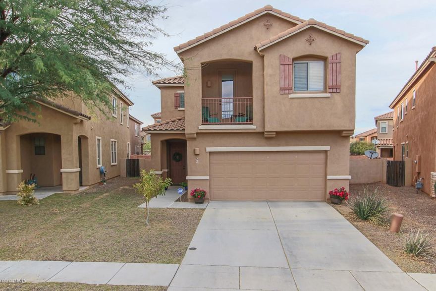 STUNNING HOME!!! 4 spacious bedrooms, 2.5 bath home will amaze the most discriminating buyer!  Soaring ceilings, lots of natural light, 18'' diagonal tile in traffic areas, with wainscoting in dining area.  The kitchen features cheery cabinets, granite counter-tops, tile back-splash and stainless steel appliances.  Exterior and interior surround sound.  Cozy gas fireplace in family room adorned with tile trim. HUGE backyard has pavers and LOTS of natural grass with sprinklers on timer for everyone to enjoy!! All this in the Award Winning Community of Rancho Sahuarita.
