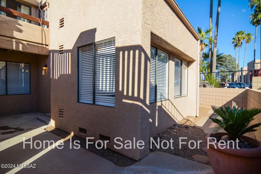 Beautifully remodeled Condo. Located in a convenient West Tucson Location. Rich wood look LVP flooring. Remodeled kitchen with SS appliances. New interior paint. Updated modern bathrooms. Wood burning fireplace in living room. One assigned carport. Covered balcony. Fenced yard. HOA includes many amenities New light fixtures and door hardware. This home shows beautifully.