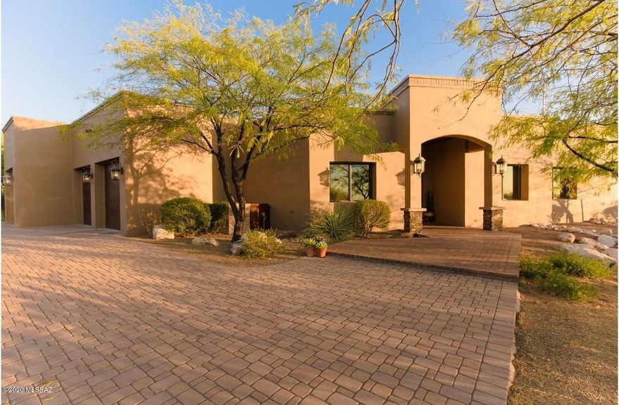 This Saguaro-studded, resort-style home awaits you! Custom, contemporary desert retreat located on 3.3 acres in desirable gated neighborhood of Saguaro Trails. Since first impressions matter, this home will wow you with its paver driveway, rusted garage doors, mature landscape and vaulted entry. The floor plan is perfect for entertaining with wide open spaces, separate formal living and dining, wet bar, and bonus game room. Professionally designed yard with pool, spa, stacked stone patio, fireplace and bbq. Don't miss the detached artist studio with electric/AC! Kitchen has granite countertops, Alder cabinets, custom built-in storage, massive island with gas cooktop, GE Monogram SS appliances, walk-in pantry. Spacious owners suit with plenty of sitting room in front of gas fireplace. Travertine floors and shower with separate vanities, custom mirrors, sconces, and large walk-in closet with built in cabinetry. Minutes from Saguaro Natl Park, shopping, dining & more. A+ rated Vail schools.