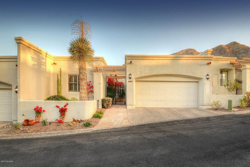 Gorgeous remodeled El Diamante Townhouse in the prestigious gated Skyline Country Club on one of the most beautiful streets in the community. The home features a gated courtyard entrance & a bright & open floor plan with picturesque windows that capture the dramatic views of the Catalina mountains. The beautifully remodeled kitchen contains the latest slate grey appliances & a large island with a gas cooktop. Perfect for entertaining with bar seating that looks into the kitchen & a wet bar conveniently located near the stunning, serene back deck. The spacious master bedroom is completed with a large bathroom featuring an over-sized shower and jetted tub. You will love being walking distance from Skyline CC as you enjoy the use of of limited club amenities. Tucson living at its best!