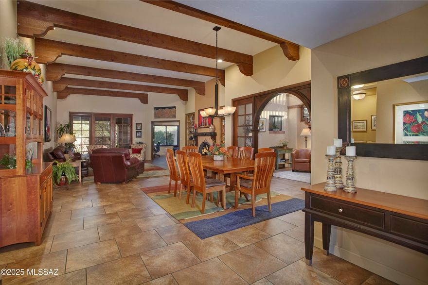 Gated San Miguel! A charming enclave of 40 homes located in the heart of Central/North Tucson. This home is located at the rear of the community, has a wonderful courtyard gated entry, boasts 3 bedrooms and 3 en-suite bathrooms. The entry, living & dining room have stunning wood beams and a fireplace with a live edge, hand made mesquite mantle, and provide a full view of the large rear yard (and putting green). Solid masonry stucco construction, built by David Baird. Recent upgrades include Anderson windows, 3 tinted skylights, new hot water heater, off-the-wall twin beds & new water line from house to main. Community has a clubhouse, pool, spa, and tennis & pickle ball courts. Close to TMC, Whole Foods, biking, hiking and ''the loop''.