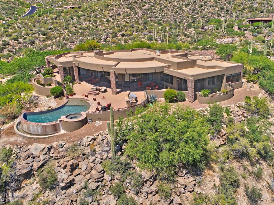 Gorgeous panoramic views throughout this stunning home.  No details have been overlooked.  The cooks kitchen is masterfully designed and appointed.  Including a huge walk-in pantry.  The impressive wall of windows in the great room opens to bring in that natural beauty.  The private master suite is a perfect retreat.  Surrounding you in breathtaking views and highlighted with a beautiful fireplace and  luxurious bath.  Outdoor living space includes expansive patio, pool, spa, built-in BBQ, firepit and more of the incredible views of Canyon Pass.  Media room/5th bdrm is perfectly outfitted to impress and entertain.  Superior finishings and elegant touches throughout make this a spectacular home, one not to miss.