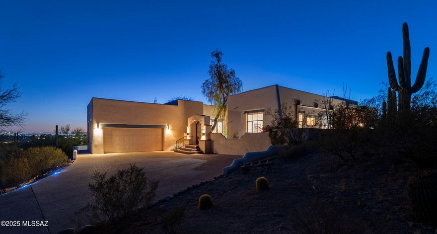 Nestled within 2.11 acres of the untamed Sonoran Desert, this residence stands as a dialogue between architecture and landscape. Designed by Marc Gerson and built with precision by Jed Paradies on one of the most sought after streets in ''The Foothills,'' while offering panoramic views that frame the raw beauty of Finger Rock and the Catalina Mountains to the north. To the south, the distant Santa Rita Mountains, the University of Arizona, and the ephemeral glow of A Mountain's Fourth of July fireworks anchor the horizon. Upon arrival, a sculptural gate opens to reveal the first of five patios. These outdoor spaces extend the interior into the surrounding desert, each positioned with intentionality. Two patios adjoin the primary bedroom, while others flow from the living room and dining areas, culminating in an interaction with the newly re-plastered pool and spa- a serene reflection of the Arizona sky. Through nine skylights, sixteen expansive glass doorways, and meticulously placed windows, light moves effortlessly through the home, creating a rhythm of brightness and shadow while maintaining a sense of privacy.

A temperature-controlled wine cellar, calibrated for 675 bottles, and paired with a concealed beverage center featuring refrigerated drawers, offer refined solutions for curated living. Each of the four bedrooms, with walk-in closets and en-suite baths, serves as a sanctuary. The tranquil sound of water, both from the pool's edge and a fountain near the living room, layers a sensory dimension to the environment, transforming the home into a retreat, while being within mere moments from La Encantada and the conveniences of Campbell Avenue, yet grounded within the desert's vastness.

The kitchen is an exercise in precision and quiet luxury. Appliances by Wolf, Monogram, and Bosch integrate seamlessly into millwork crafted by Canyon Cabinetry, while the gas range's roof-mounted ventilation whispers its function into the background. The thoughtful composition of materials extends to the fireplaces in the great room, living room, and primary bedroomeach a nucleus of warmth and intimacy within the home's spatial hierarchy.

In the living room, where scaled wooden ceilings soar, and unique lighting fixtures establish a sculptural presence. Spotlights gently enhance the home's curated art, while under-cabinet illumination in the kitchen and beverage center creates a soft, inviting glow. Outside, lighting along the patios blends function and form, guiding residents and guests with an understated elegance.

The landscaping merges seamlessly with the architectural language, celebrating the native beauty of the Sonoran Desert. Chilean mesquite, desert museum palo verde, and succulents stand alongside vivid blooms of bougainvillea and Mexican bird of paradise, attracting hummingbirds and butterflies alike. Anchoring the composition is a young Chinese pistache tree, its eventual stature promising shade and seasonal transformation. Two irrigation systems balance the natural austerity of the desert with the home's cultivated grace. This is not merely a residence; it is an environment, a convergence of light, material, and space that invites contemplation and harmony.