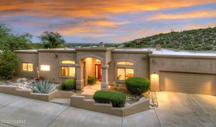 Stunning city light views from inside & out are the focal point of this crisp & modern home nestled in the Catalina foothills adjacent to acres of common area. Spacious great room offers living area w/dramatic FP & dining area. Formal dining room can be used as an office/study. Lovely kitchen w/rich staggered cabinets, SS appliances, beautiful granite counters & backsplash. Very private backyard w/sparkling pool, large covered patio & wonderful city light views. Generous master w/luxurious bath includes a soaking tub, walk-in shower, dual sinks & large walk-in closet. Fabulous rec-room w/wetbar offers flexible addl living space. Gorgeous marble tile throughout most of the home. 2 addl bedrooms, fully updated guest bath, 3-car garage w/storage cabs & workbench round out this amazing home!