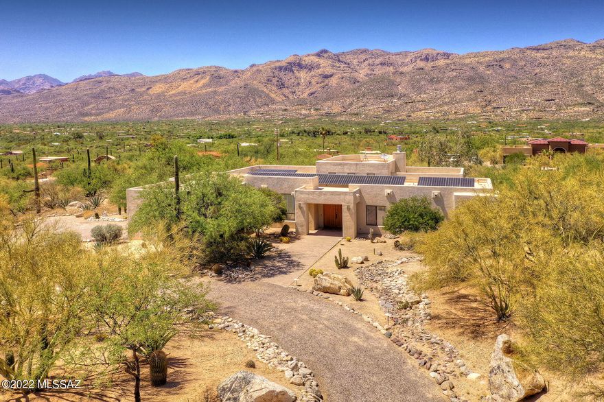 Million Dollar Mountain Views from this Stunning property on over an acre. This Contemporary, solar home in Tanque Verde Valley, is within walking distance of Agua Caliente Park. A Bright open floorplan w/high ceilings & large windows greet you as you enter the home. Recently remodeled kitchen has quartzite countertops w/waterfall edge, large island,6 burner gas range, farmhouse sink & breakfast area. Beautiful wood like tile throughout the house. Great Room has floor to ceiling tiled gas fireplace, dry bar w/marble backsplash & ss wine fridge. Master suite has floor to ceiling windows, private covered patio, soaking tub, walk in shower & two separate vanities. Backyard is an entertainers' delight. Covered patio, pool w/water feature. Welcome home!