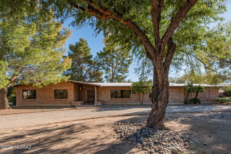 Original Owner classic Tucson Country Club Ranch. Built in 1968, and tucked away on a cul de sac, this handsome used brick masonry home is sited on .56 acre lot with a heated pool, mature trees and shrubs. Grand proportioned rooms will not disappoint. Features include two fireplaces, home office, breakfast room, exercise room, steam shower, central vac, and an abundance of built in storage and shelving throughout.