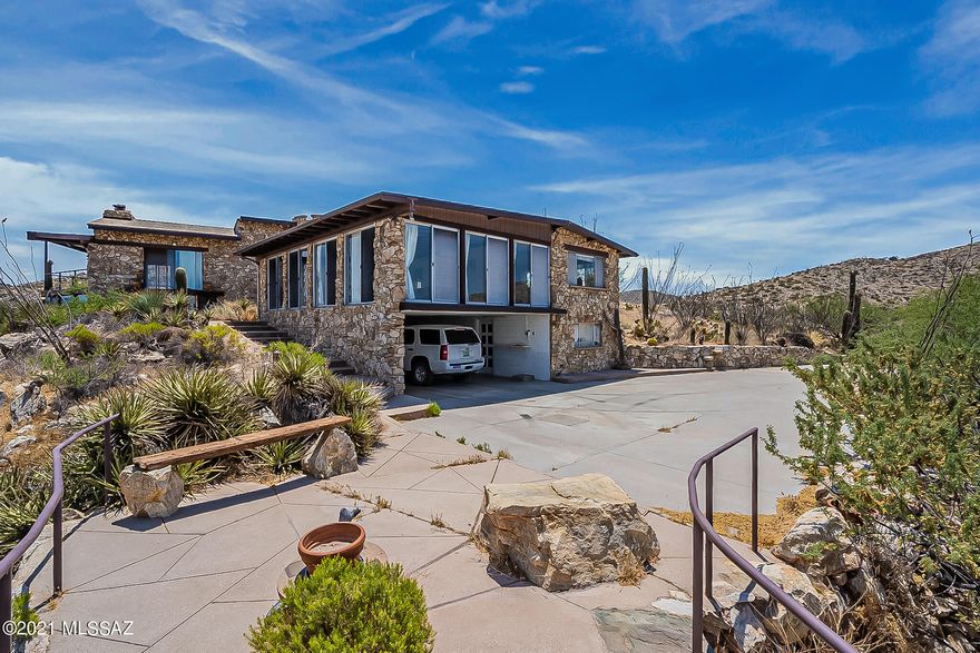 Off grid living in a Unique Stone home built by hand by a master stone mason and his wife. Call for site visit date and time. Do not attempt to access property. Roads are private and road is blocked by locked gates. This estate home and guest house is on the highest isolated peak in the Tortolita Mountains. Outside dining patio and breezeway, living space paired with loft bedroom.  Generator and some solar power.  Multiple viewing windows to capture the wonderful views, elegant double sided open face stone fireplaces. Hickory cabinets, kitchen off great room. Single carport and workshop.  Elegant and artistic touches throughout.  One of a kind Home.  Call for site visit date and time. Do not attempt to access property. Roads are private and road is blocked by locked gates.