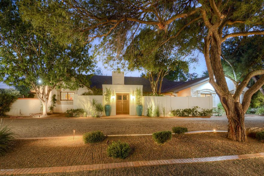 INCREDIBLE PRICE REDUCTION 4/16/18! TUCSON COUNTRY CLUB. Beautiful courtyard entry, lovely pathways, lush landscaping, amazing outdoor living areas, interior beams, fireplaces & tile floors make this home reminiscent of the French Countryside!  So many features: Gracious formal rooms/w/2 seating areas, masonry fireplace & built in buffet.  Totally updated gorgeous kitchen! Center island, top of the line SS appliances including gas cooktop. Huge walk-in pantry & lg breakfast nook. Magnificent rock, masonry frplc in beamed, ceiling family rm. Lovely mstr. suite complete w/ dressing rm & walk-in closet. Separate gst suite has a kitchenette, liv rm, bedroom & bath!  2 additional oversized bedrooms. Large 2 car garage with storage. INVITING POOL/SPA - Citrus trees & fountains!  ALARM!