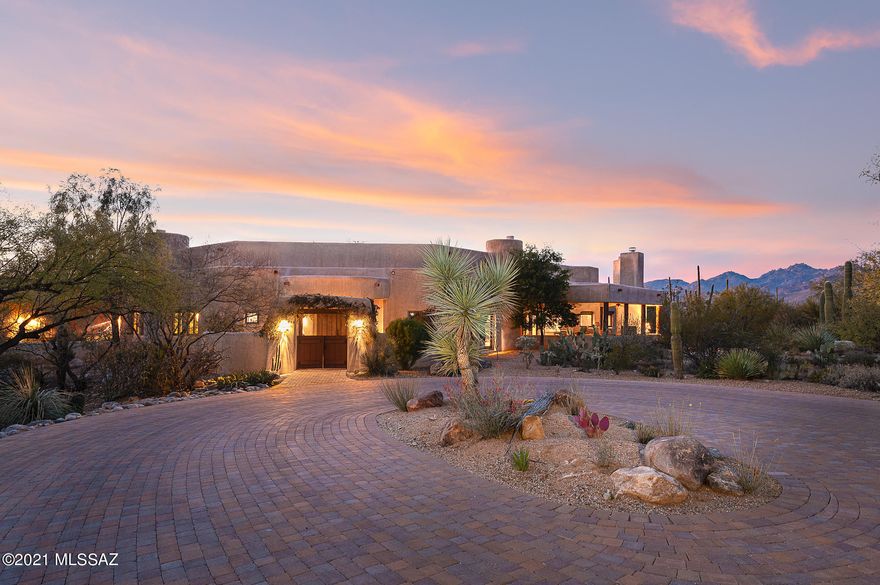 Live in complete privacy & seclusion w/ mountain views on an 8.43-acre gated residence situated on the gentle mountain slopes at the intersection of the Catalina & Rincon mountains in the lush Tanque Verde Valley, the green jewel of the desert that is traversed by 2 notable seasonal creeks. Horses are allowed at this sanctuary-style estate designed by famed architect Myron Goldfinger.  Located minutes from the famed Tanque Verde Guest Ranch, this area is steeped in rich history & is designed for sparse population providing starry nights, dreamy sunrises & sunsets, mesquite bosques & abundant desert wildlife. Renowned builder Ray Birch delivers meticulous craftsmanship carefully executed in the distinct Santa Fe style characterized by double adobe construction, CLICK MORE imperial plaster, custom Butler windows and doors, exposed natural wood viga beams, saguaro ribs, honed flagstone floors and multiple patios and fireplaces. Enter through the private gate and follow the long, winding driveway lined in pavers to large circular motor-court. Enchanting gated courtyard with fragrant plantings greets guests.  Feel transported upon entering this impeccable southwestern style home built around a large interior courtyard with built-in BBQ that sets the stage for true indoor/outdoor living that calls people to the desert.  Understated and supremely upgraded chef's kitchen with center island, copper hood and top of the line appliances from Sub-Zero and Viking opens to a casual family room perfect for gathering with friends and family.  Re-imagined oversized kitchen pantry area with Sub-Zero refrigerator and incredible storage.  Formal dining room with large picture window to capture scenes of the desert. Powder room at entry for guests.  Exquisite formal living room with coved, barrel ceiling and built-in bookcases leads to exceptional, eastern exposure outdoor living room with fireplace, built-in BBQ, refrigerator and sink.  Two master suites each with spacious and well-equipped bathrooms, walk-in closets and intricate wood ceiling treatments. 2 additional en-suite guest bedrooms are warm and inviting resort-style retreats, each with their own fireplaces.  Office/5th bedroom provide flexibility of space and connects to guest bathroom.  Large laundry room with sink and extra storage.  Over-sized, epoxied 3-car garage is flanked by large storage areas and a workshop.  Multiple patios surround this home for different views and exposures.  Sport court with basketball hoop.  Enjoy all that Tucson has to offer with this Santa Fe home like no other with "A" rated Tanque Verde School District, 2 golf courses, Mt. Lemmon, Saguaro National Park East and a multitude of hiking and biking trails from your doorstep.  Shopping and restaurants 10 minutes away, all major shopping outlets available in the immediate area.

Additional acreage: Current owner acquired and added 3.31 acre lot to increase the 5.12 acre lot at time of purchase to a total of 8.43 acres.  Both lots are combined on one tax code but the development potential remains on the additional lot.

Current Owner Additions and Upgrades:  See documents tab for full list--replaced long asphalt driveway with pavers-added deep covered patio/outdoor living room-kitchen on east wing of the home with big fireplace, built-in BBQ, sink and refrigerator, renovated and re-designed kitchen with new counters, re-designed butlers pantry with Sub-Zero refrigerator.

In the area: Live in seclusion with proximity to schools, a myriad of outdoor activities and golf clubs. Located in the "A" rated, excelling public school district-- Tanque Verde school district.  Tanque Verde Elementary School, Emily Gray Middle School and Tanque Verde High School all very close and are all high-performing schools with a variety of activities and youth programs. 
 
Less than 5 minutes away from the 49ers Country Club. 
Spread over 110 acres, the course is known for its lush, mature landscaping and excellent course conditioning. 
A full service restaurant open to the public, The Rincon Mountain Grill, has been expanded and upgraded serving breakfast, lunch and dinner 7- Days a week with various specialty offers.
Forty Niners CC has a swim team for the kids, summer camps, and several events throughout the year.  
New workout facility for fitness training is fully equipped, 24 hour access and tons of fitness classes.

Just 10 minutes away is the Arizona National Golf Club:
Arizona National Golf Club, designed by Robert Trent Jones Jr, was voted best public golf course in Tucson, Arizona. 



Convenient location to get to Mt. Lemmon.with a summit elevation of approximately 9000 ft. is the highest point in the Santa Catalina Mountains. It is located in the Coronado National Forest north of Tucson, Arizona and is an incredible retreat from the hot temperatures in Tucson in the summer. Enjoy skiing, hiking, biking and rock climbing.  
Saguaro National Monument East-Located on the east-side, Tucson's cactus forest  tucked within Saguaro National Park East and nestled up against the Rincon Mountains  is as starkly beautiful as any primeval forest you've ever seen or imagined.


Horses: This property is zoned for horses and there is plenty of room to add horse facilities to fit your individual needs. 

 Living in this rural area of Tucson provides several horse boarding facilities and horseback riding opportunities. Bobbi Houston's Horse Riding is close by and hosts rides in the Saguaro National Park.