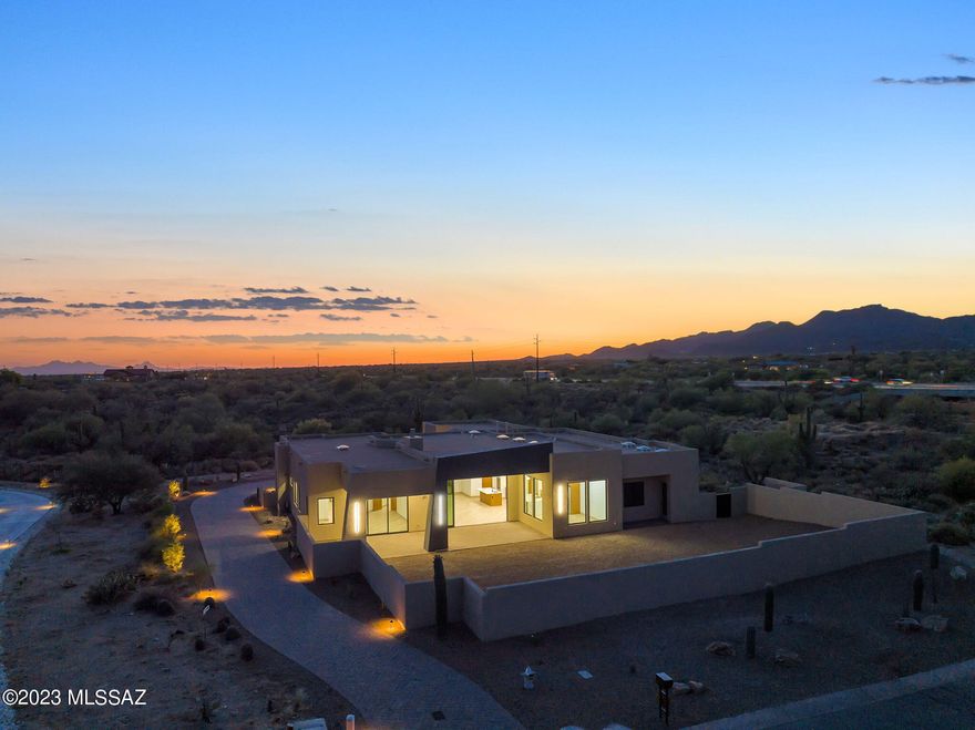 New Construction at sheet rock stage price  ranged  $1,850,000- $2,300,000.  Spectacular  Contemporary  in Oro Valley on 3.4  acre lot by award winning builder Homes by Copper Canyon.  4 bdrm 3 1/2 bath home  with back facing east to capture Catalina Mtn views.  Open floorplan that flows from great room to kitchen and dining nook.  Features include 15' Retractable sliding door, 5' glass pivot entry door with sidelights. High end finishes throughout. The pictures are of this same floorplan built and occupied on another lot in the community.  Builder estimates completion Mid 2026. Call to schedule a viewing and meet with builder.