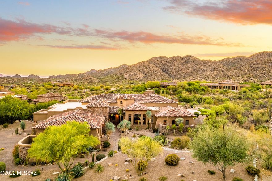 Fabulous Tuscan style masonry home with resort-like yard and serene desert, sunset and Tortolita Mountain views in guard-gated Stone Canyon!  Perfect 3,550 SF split layout includes Great Room with Fpl and huge disappearing wall of sliding window doors, 3 Suites, Powder Room, and Office/Den!  Chef's kitchen with high end appliances, gas cooktop, wine refrigerator, walk-in pantry, large Viking ref/frzr and informal dining nook with separate patio access. Deep cov'd expansive patio includes built-in BBQ, remote controlled awning & sunscreens, gorgeous pool & spa, putting area, and fenced yard.  Oversized 2.5 car garage offers workshop area plus lots of storage. Updated in 2020-2023 with new HVACs, water heaters, interior & exterior paint, roof & landscaping (see Docs). Club Membership req'd.