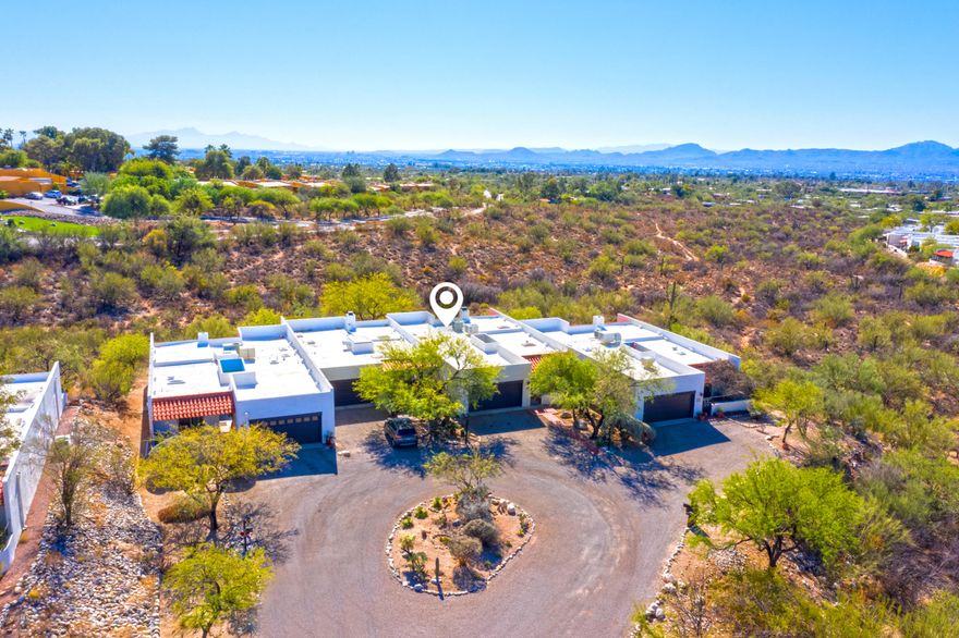 Located in a desirable intimate community next to the Westward Look Resort, this town home backs up to an arroyo of natural desert tree, shrubs &  City VIEWS!  One of the best locations in the community! The home features a courtyard entry,  2bdr, 2ba plus a 3rd room for an office, crafts, or guests. 2-car garage with attached storage, & work bench, & freezer. Gracious foyer entrance.Covered front & back patios. Excellent for entertaining.  Master bdr has a walk-in shower and walk-in closet.  Home is situated off the road providing a lot of privacy.  All new carpet and fresh paint makes it move-in ready.  Quick close is possible. Seller's daughter is licensed to sell RE in both NH and MA. HOA includes basic cable, road maintenance, pool & spa heated year round, trash pick up, club house, and landscaping of common grounds