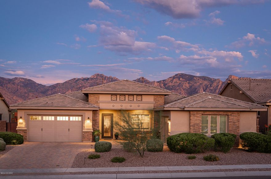 This stunning turn-key home in the highly desired gated community is located on a prime lot with east facing uninterrupted views of the Catalina mountains from the covered patio and custom pool. The 4 bedroom, 3 bath, split floorplan features gorgeous 20'' porcelain tile throughout with newer carpet in the bedrooms. Updated to be a true chef's kitchen you'll find a subzero 42'' refrigerator, subzero wine fridge (fits 146 bottles!), oversized granite counters, Wolf stainless cooktop, double oven, chrome pot filler, and 42'' upper Sierra Vista Maple-Espresso cabinets! The dreamy backyard is perfect for entertaining, from the pool (installed in 2018) to the newly built outdoor kitchen including a Blaze grill and double keg, it is the perfect place to watch the Catalinas turn pink at sunset. Enjoy the calm and quiet of Rancho Vistoso in the sought after The Pinnacle community, located adjacent to the community center and pool.  An abundance of shopping, restaurants, and entertainment are  are conveniently located nearby! Close to the loop and Catalina State Park, this home and location has it all. Don't miss your chance on snatching up this gem to make it your future home!
