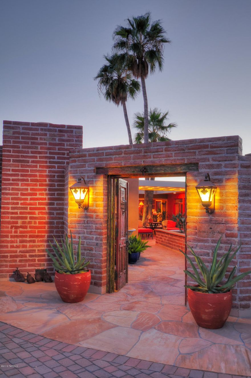 VOTED ''BEST'' IN MLS REALTOR TOUR IN APRIL!
Stunning Mid-Century Ranch you will find in Tucson! Hacienda de las Tres Palmas sits High above Pima wash, at the end of a long drive. Tastefully updated estate,  featured in Tucson HOME Magazine & truly feels like a resort! 3,400 sq.ft. of glorious indoor lvng. space and a whopping 2,800 sq.ft. of outdoor entertainment areas including a custom stainless & granite exterior kitchen, flagstone flooring throughout, custom tile on fireplace surrounds and in  bathrooms, built-ins, whole house sound system, new Anderson windows, and recent landscaping front & back. Generous master suite has its own enormous owner's office, walk-in closet, laundry room, & outdoor stone-walled shower. Views & Privacy! If you love the Arizona lifestyle, this home is you
