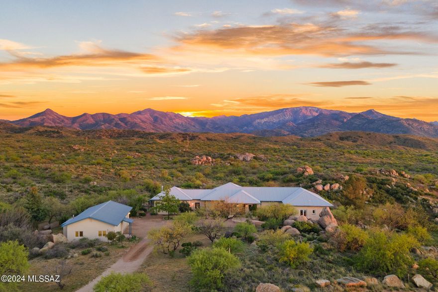 STUNNING setting for this custom upscale rustic farmhouse style home in the heart of Oracle! Bordering state land, this energy efficient ICF (insulated concrete forms) built home was designed to capture the serenity of the environment in each room by creating a seamless segue from inside to outside. Every window showcases jaw-dropping views of the Catalina mountains, and you can reach out and touch the pristine state land from your property line! Artist designed home boasts an open floorplan, concrete flooring throughout (with the exception of carpet in the primary bedroom), TALL ceilings and tons of natural light. There is a cook's dream kitchen with gas cooktop, subzero fridge, custom cabinetry, tons of counter space and a huge island topped off with soapstone countertops. The flexible floorplan could easily accommodate a guest wing, several office areas, or whatever your needs may be! The outside vistas will leave you speechless and must be experienced in person. There is a freestanding 2-car garage with an attached art studio (or future guest quarters as it's heated/cooled, has water and electric and is plumbed for an additional bathroom). There is a vegetable garden area, and a fenced side yard for pets. At a 4300' elevation, come view this one-of-a-kind home and experience cooler temps and all that small town living has to offer!
