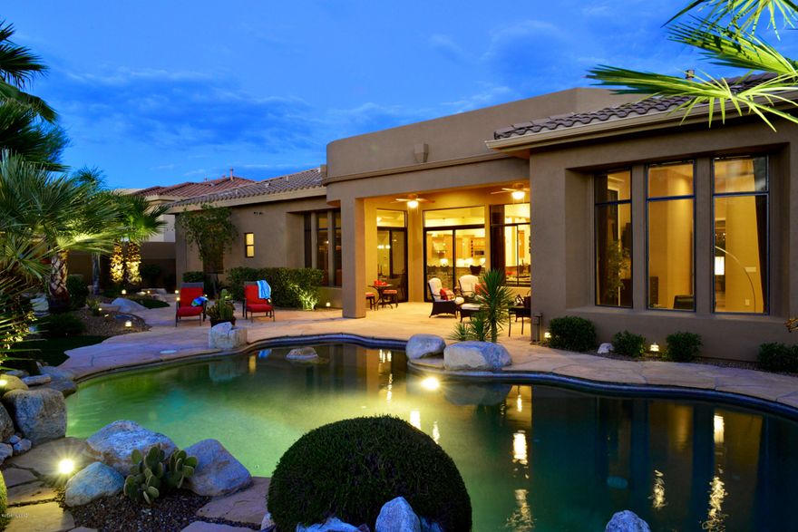 Gorgeous contemporary built by Monterey Homes on cul-de-sac in upscale 14-home gated community in Rancho Vistoso, a master planned development in Oro Valley. Main house (3,377 SF) offers Great Room layout, formal and informal dining areas, den/office, powder room, 3 suites, large laundry and 3-car garage. Guest house (402 SF; 1BR/1BA) is accessed off entry courtyard. Spacious chef's kitchen: gas cooktop, 2 ovens, prep island with sink, Alder cabs, slab granite and full backsplash. Stacked stone accent walls and beautiful Travertine floors (2 suites with carpet). Splendid master with luxurious bath. Lots of storage. Rear yard offers privacy and relaxation: resort style pool, flagstone patio, soothing waterfall, and built-in BBQ with pizza oven. You'll love this inviting, peaceful retreat!