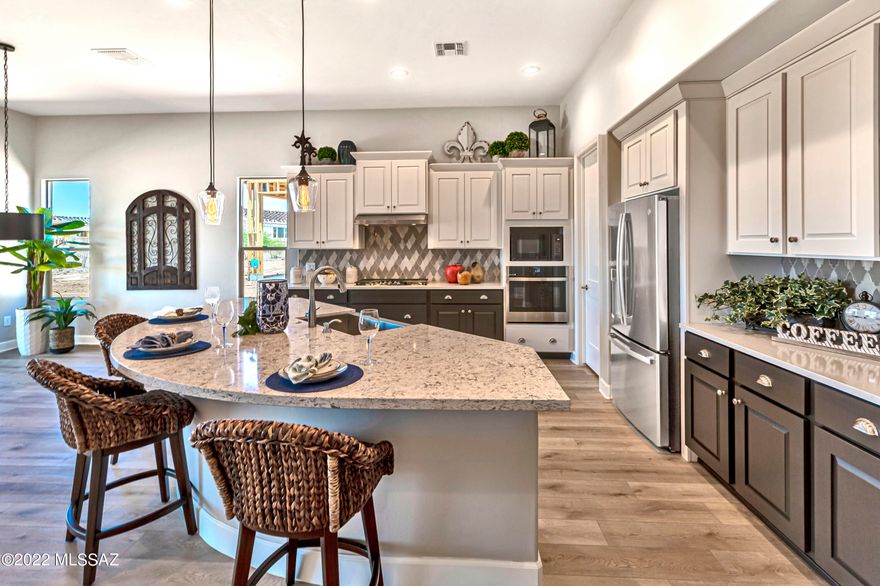 Brand New, Never Lived In! Superior design and exquisite finishes are featured in this Modern Style entertainers' dream home. This magnificent Vienta floor plan in SaddleBrooke Ranch is loaded with upgrades. The open floor plan features many special touches including upgraded cabinetry, luxury vinyl plank floors, Quartzite kitchen counter tops with designer backsplash, upgraded light fixtures and so much more.
Cooking is a chef's delight in this bright open gourmet kitchen that features a generous center island, upgraded stainless steel appliances and plenty of storage including a large walk-in pantry.
Owners' suite offers a luxurious bath, freestanding soaking tub, walk-in shower and a spacious walk-in closet with upgraded built-ins for additional storage The oversized den is great for your home office, separate TV room or library. Two ft extension on entire back of home. Four ft expanded full 3 car garage offers water softener, tankless water heater and epoxy floors. Entertain year round in your spacious backyard with covered patio, enchanting gas fireplace and rolling shades. Front and backyard landscaping to be installed soon.
If you've been imagining yourself in the lap of luxury at SaddleBrooke Ranch, look no further. This is the home of your dreams!