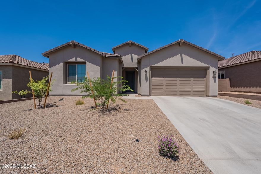 Discover this modern luxurious 3-bed, 3-bath home in gated Saguaro Reserve at Dove Mountain! The 2,518 sq. ft. floor plan boasts high ceilings, recessed lighting, and dual-pane windows, with ceramic tile in living areas and plush carpet in bedrooms. The chef's kitchen impresses with 42'' cabinets, quartz countertops, a gas cooktop, and a top-tier refrigerator. Retreat to the spa-like primary suite with a huge walk-in shower, stunning double vanity, and a walk-in closet. This home features a prewired surround sound system in the great room, ceiling speakers on the patio, and 2 hotspots on the ceilings for seamless connectivity. Plus, enjoy a three-zone A/C system for personalized climate control. Thoughtful storage throughout and an inviting outdoor space complete this exceptional home!