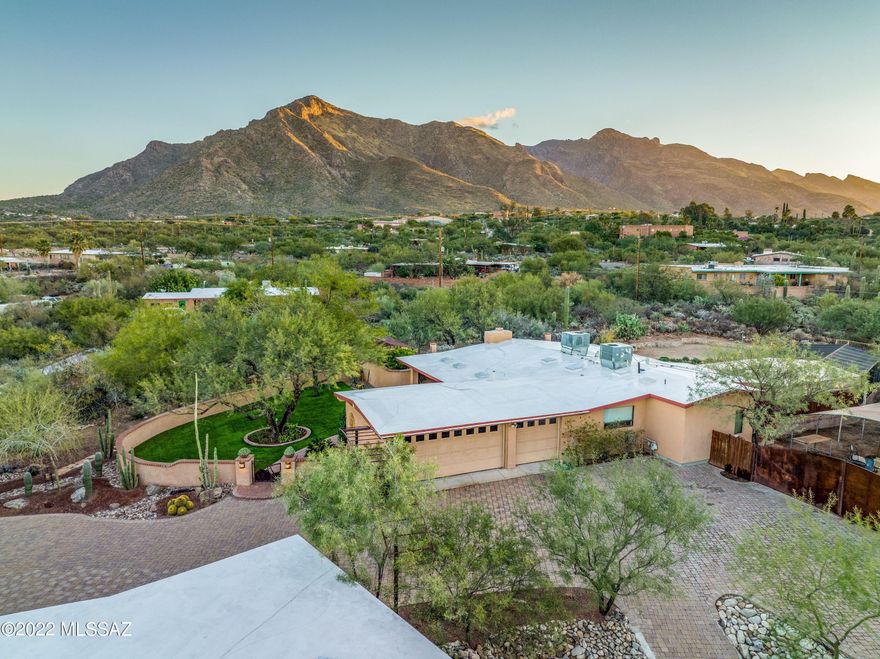Tucked away in the highly sought after Suffolk Hills neighborhood is this immaculately maintained 3 bed 2 bath home sitting on 1.2 acres and surrounded by breathtaking views of the Catalina Mountains.  This gorgeous home features granite counters, stainless steel appliances, professional landscaping, a gated custom brick driveway as well as a gated and covered RV parking area with electrical hookup including multiple 220V service outlets on the property. Also featured is a pool, custom hickory and cherry wood cabinets as well as solid alder wood doors in main house.   Guest house features 1 guest bath, 1 full bath in bedroom, large living and kitchen area, and custom alder wood doors and cabinets.  Guest home has its very own yard, laundry room, garage, deck, and a basement with ext access