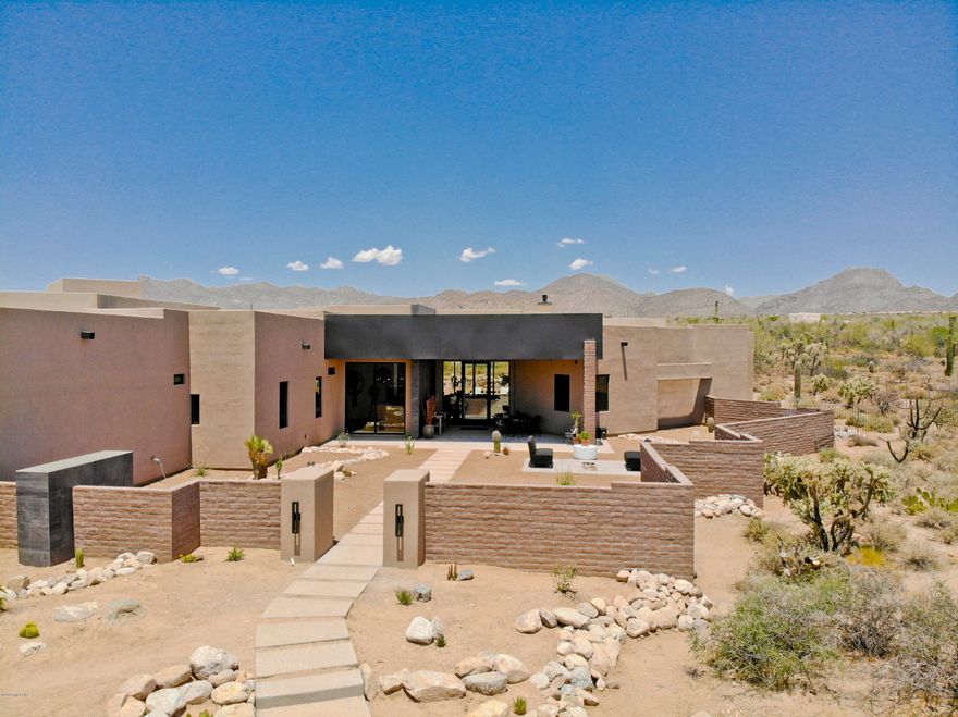 Simply SENSATIONAL contemporary styled home with a MASSIVE 4,500 sq. ft. garage that's perfect for a car enthusiast, RV owner, artist, or other hobbyist. This phenomenal luxury home is sited on a large 4.15 acre lot & delivers unparalleled craftsmanship from 4th generation builder John Herder who is renowned for his quality & attention to detail. Situated within the gated community of The Estates at Tortolita Preserve, you'll appreciate the protected views of the Tortolitas & Tucson Mountains. That enormous garage offers heating & cooling, covered RV storage, workshop space, compressed air lines, addt'l laundry hookups & so much more! A commercial grade rear sliding door system & floor to ceiling front windows deliver amazing mountain views! Now fully completed & new pictures coming soon!