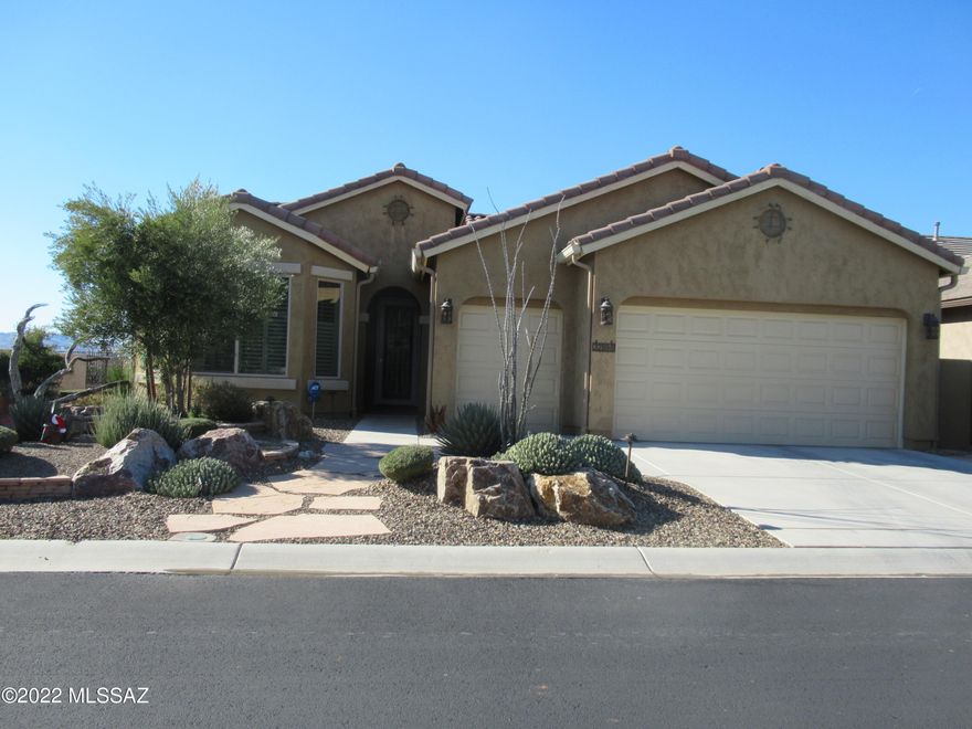 Relax on the patio of this beautiful Dolce model with panoramic views of the Tortalita mountains across an open desert vista.  The patio is tiled with a flagstone extension under an extended ramada for added shade.  Bay windows grace the dining area, guest, and master bedrooms.  The well appointed kitchen boasts a GE gas range with convection oven and quartz countertops.    The extended garage includes storage cabinets.  Why wait to build?!