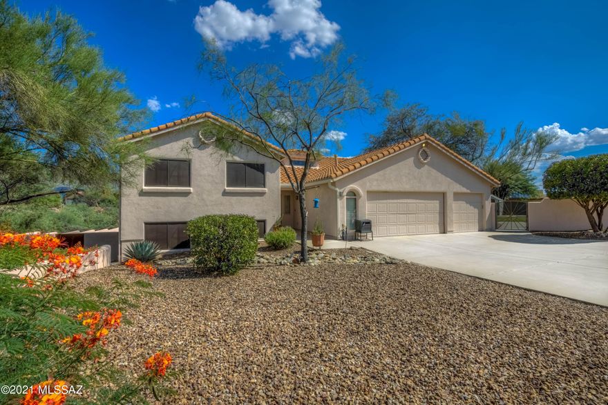 Hurry this one won't last long! Majestic Catalina Mountain Views and Tucson city lights abound this gorgeous 1.19 acre custom home in Oro Valley. Large PebbleTec Pool & surrounding lower entertainment space completely re-designed/remodeled in 2018. Park-like backyard is large & flat w/mature citrus trees, two rose gardens, & real grass for your entertaining pleasure. Great for parties and even weddings! 3 Incredible custom gates, were hand crafted by Ken Webb of Quiet Bear Art. Inside you'll find a beehive fireplace to gather family and friends around enjoying the view. Up 7 steps to the primary bedroom that has a beautifully remodeled modern bathroom. And only 7 steps down you your very own walk out basement to the pool and 2nd entertainment area. There are 2 guest bedrooms up and 2 bedrooms down as well as the large family room w/a custom wet bar ready for entertaining. The other 2.5 guest bathrooms have also been remodeled with gorgeous Italian tile. The kitchen is waiting for its next owner to make it their dream kitchen. It has original Jenn-Air appliances that are still going strong, dishwasher is newer, center island, loads of cabinet space, large pantry closet, and the breakfast nook overlooks the Catalina Mountains. HVAC system was replaced in 2016 and is the top of the line Lennox. Super low HOA's only $7 a mo. Don't miss this opportunity to live in Monte Del Oro!