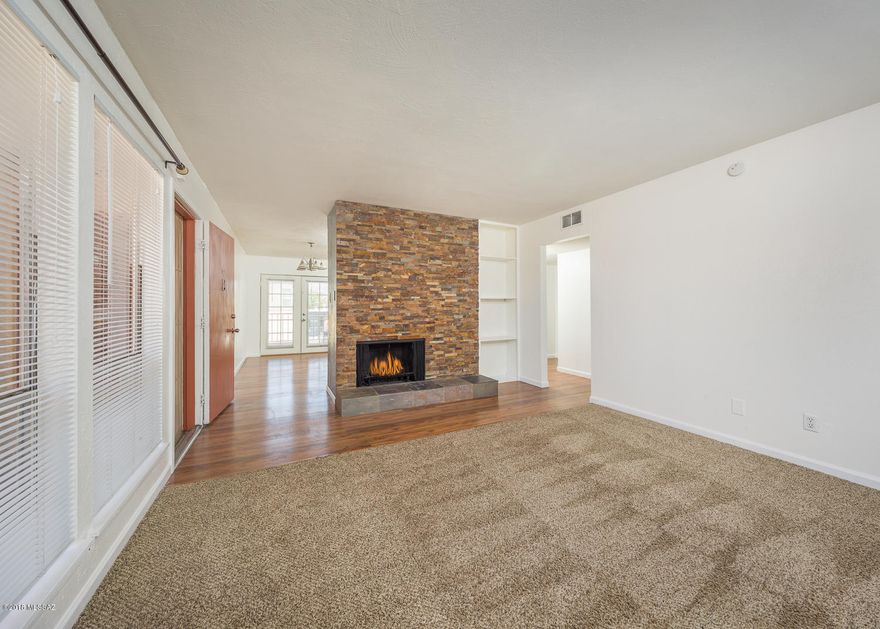 Sharp and Clean two bedroom two full bath Condo. Great Location, close to shopping, entertainment and easy commute anywhere. SS Appliances all stay. Kitchen modification opens up kitchen and gives it great feel. Newer Cabinets, Newer AC, Fresh Paint throughout this home.New Blinds, Carpets just cleaned.  Nice french doors to Covered Balcony, washer and dryer hook ups too.  Beautiful Stone fireplace. Two full Master baths, Sandstone tiled vanities. Really clean  and well cared for.  Show today. HOA pays for water, sewer, and trash and blanket insurance policy.