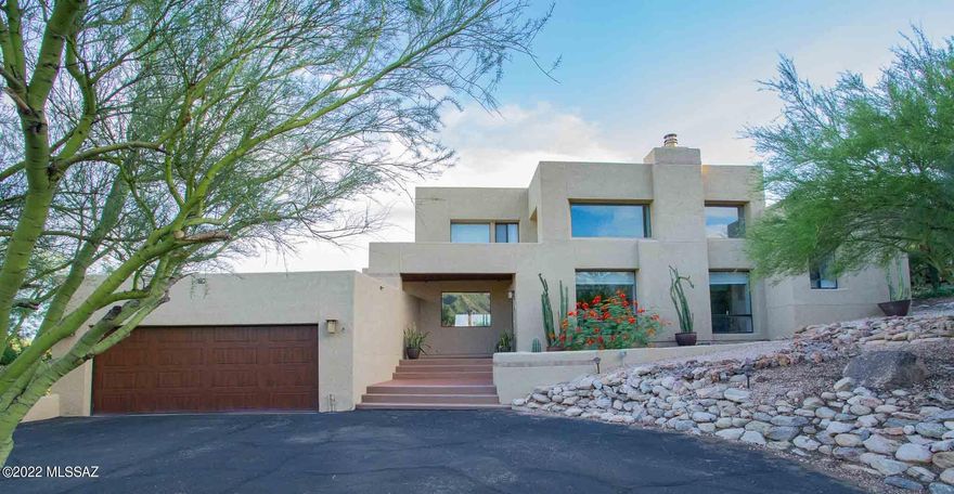 Located in desirable Cimarron Foothills Estates on large 1.41 acre elevated lot with panoramic mountain views. As you enter, this beautiful home boasts living room with high Cathedral cedar pecked beamed ceiling, fireplace & wood plank porcelain tile. Custom kitchen cabinets, granite counter tops & stainless-steel appliances. Enjoy private, elegant primary bedroom suite with huge walk-in closet, new balcony deck & lovely views of city & mountains. Jacuzzi tub in primary bathroom great for relaxing. As you step outside, you'll love the new self-cleaning & solar heated pool, built in 2019, with water fall feature & lights that you can control from your phone with the Hayward omni logic pool app. Catalina Foothills School District #16 schools. Covered porch, Pool, BBQ, gazebo, CONTINUED... concrete shell pavers, artificial grass & trampoline make this back yard great for entertaining. Two car garage with plenty of cabinets and storage room. Incredible Foothills location within minutes of the best shopping & restaurants Tucson has to offer. Close to world-class golf resorts, country clubs & hiking & biking trails including Sabino Canyon.