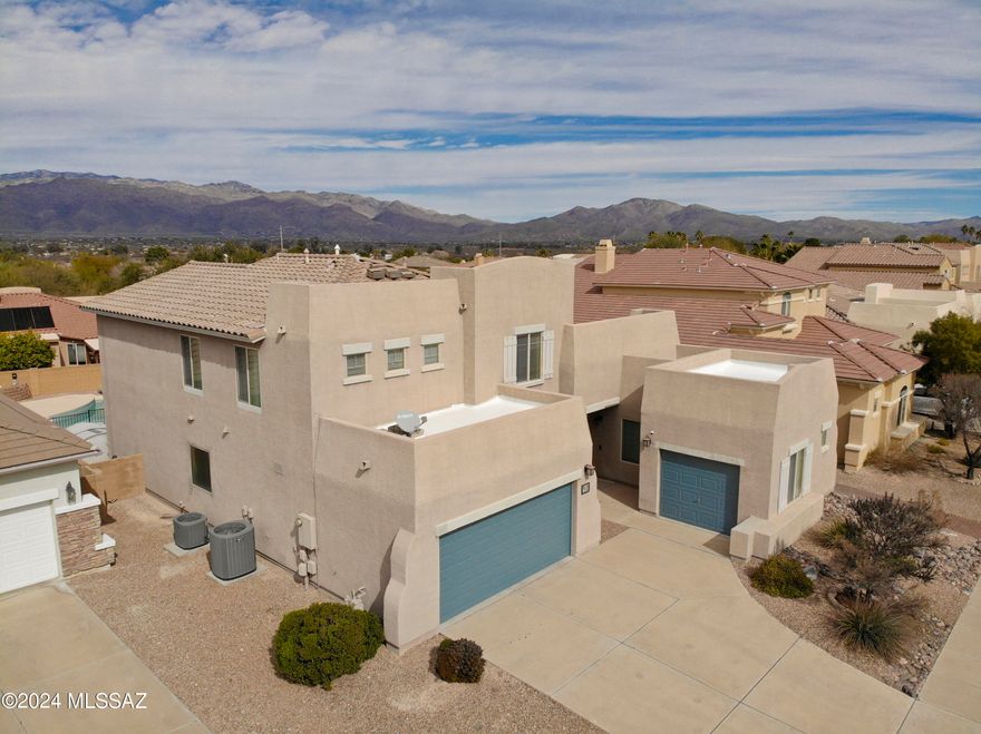 This beautifully maintained and upgraded two-story home with primary suite on the main floor has Catalina mountain views and a fully landscaped backyard with pool. Upgrades include engineered wood floors and built-in cabinetry in the downstairs office, a sound insulated bonus room with additional A/V wiring in the loft, bagless central vac, epoxy floors in both the 2-car and 1-car garages, a built-in gas BBQ next to the artificial turf lawn, a newer pool pump, 2024 water heater, and a full kitchen remodel in 2016 that extended soft-close cabinets and granite counter space into the breakfast nook. This is truly a move-in ready home with all appliances staying, including both the newer LG fridge in the kitchen and the bonus fridge in the laundry room.